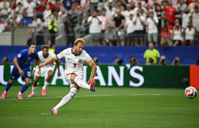 England's forward #09 Harry Kane shoots and scores a retaken penalty kick during the 2026 World Cup Group L football match between England and Croatia at the Dallas Stadium in Arlington on June 17, 2026.  (Photo by Paul ELLIS / AFP)