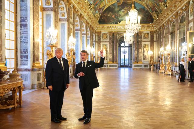 US President Donald Trump receives a tour of the Chateau de Versailles from French President Emmanuel Macron ahead of a dinner on June 17, 2026 in Versailles, France. The dinner followed the conclusion of this week's Group of 7 (G7) summit in Evian, France. (Photo by Anna Moneymaker / POOL / AFP)