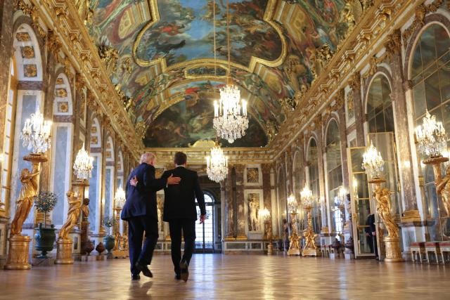 US President Donald Trump receives a tour of the Chateau de Versailles from French President Emmanuel Macron ahead of a dinner on June 17, 2026 in Versailles, France. The dinner followed the conclusion of this week's Group of 7 (G7) summit in Evian, France. (Photo by Anna Moneymaker / POOL / AFP)