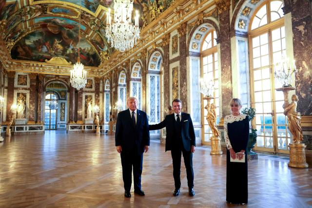 US President Donald Trump (L) receives a tour of the Chateau de Versailles from French President Emmanuel Macron and his wife Brigitte Macron ahead of a dinner on June 17, 2026 in Versailles, France. The dinner followed the conclusion of this week's Group of 7 (G7) summit in Evian, France. (Photo by Anna Moneymaker / POOL / AFP)