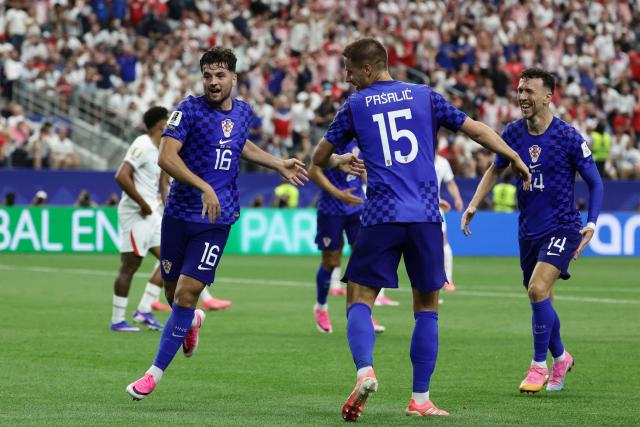 Croatia's midfielder #16 Martin Baturina (L) celebrates after scoring a goal during the 2026 World Cup Group L football match between England and Croatia at the Dallas Stadium in Arlington on June 17, 2026.  (Photo by Aric Becker / AFP)