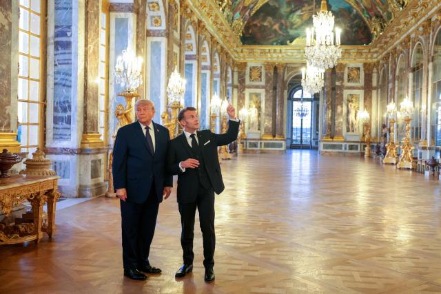 US President Donald Trump receives a tour of the Chateau de Versailles from French President Emmanuel Macron ahead of a dinner on June 17, 2026 in Versailles, France. The dinner followed the conclusion of this week's Group of 7 (G7) summit in Evian, France. (Photo by Anna Moneymaker / POOL / AFP)