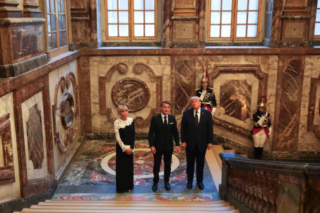 US President Donald Trump (R) receives a tour of the Chateau de Versailles from French President Emmanuel Macron and his wife Brigitte Macron ahead of a dinner on June 17, 2026 in Versailles, France. The dinner followed the conclusion of this week's Group of 7 (G7) summit in Evian, France. (Photo by Anna Moneymaker / POOL / AFP)