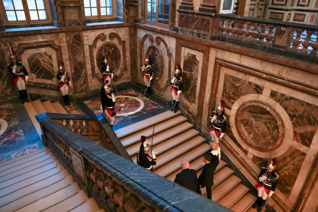 US President Donald Trump (L) receives a tour of the Chateau de Versailles from French President Emmanuel Macron and his wife Brigitte Macron ahead of a dinner on June 17, 2026 in Versailles, France. The dinner followed the conclusion of this week's Group of 7 (G7) summit in Evian, France. (Photo by Anna Moneymaker / POOL / AFP)