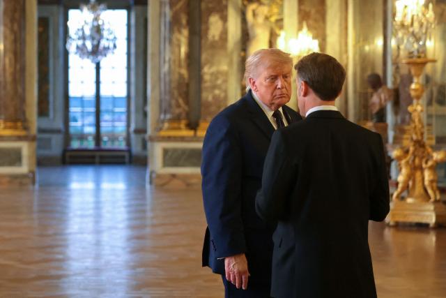 US President Donald Trump (L) speaks with French President Emmanuel Macron as hereceives a tour of the Chateau de Versailles ahead of a dinner on June 17, 2026 in Versailles, France. The dinner followed the conclusion of this week's Group of 7 (G7) summit in Evian, France. (Photo by Anna Moneymaker / POOL / AFP)