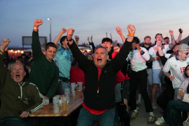 England fans celebrate as their team scored a second goal,  as they watch the 2026 World Cup Group L football match between England and Croatia, at the 4TheFans Fan Park in Brighton, southern England on June 17, 2026. (Photo by CARLOS JASSO / AFP)