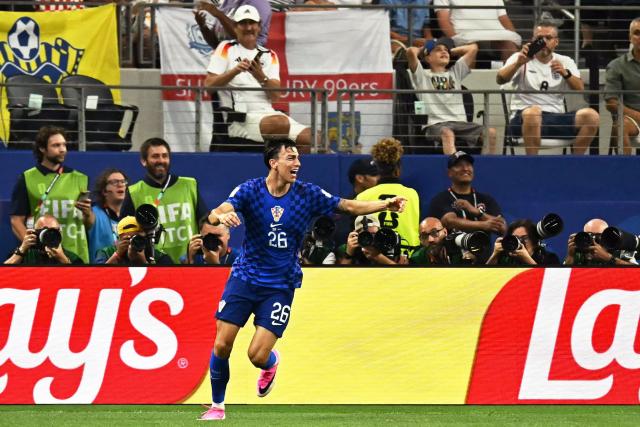 Croatia's forward #26 Petar Musa celebrates after scoring his team's second goal during the 2026 World Cup Group L football match between England and Croatia at the Dallas Stadium in Arlington on June 17, 2026.  (Photo by Paul ELLIS / AFP)