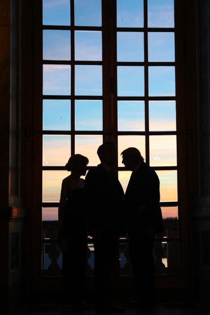 US President Donald Trump (R) receives a tour of the Chateau de Versailles from French President Emmanuel Macron and his wife Brigitte Macron ahead of a dinner on June 17, 2026 in Versailles, France. The dinner followed the conclusion of this week's Group of 7 (G7) summit in Evian, France. (Photo by Anna Moneymaker / POOL / AFP)