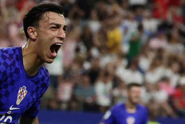 Croatia's forward #26 Petar Musa celebrates after scoring a goal during the 2026 World Cup Group L football match between England and Croatia at the Dallas Stadium in Arlington on June 17, 2026.  (Photo by Aric Becker / AFP)