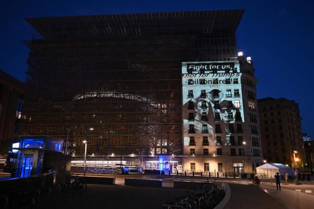 This photograph shows a projection reading "Fight for us, not for Trump's billionaires" with portraits of US President Donald Trump, Meta CEO Mark Zuckerberg, and Tesla CEO Elon Musk, on the facade of the EU Council building, on the eve of a EU Summit, in Brussels on June 17, 2026. A coalition of NGOs including Greenpeace International, People vs Big Tech, European Digital Rights (EDRi) and WeMove Europe is sounding the alarm about the influence of US big tech companies ahead of the upcoming EU summit. (Photo by Nicolas TUCAT / AFP)