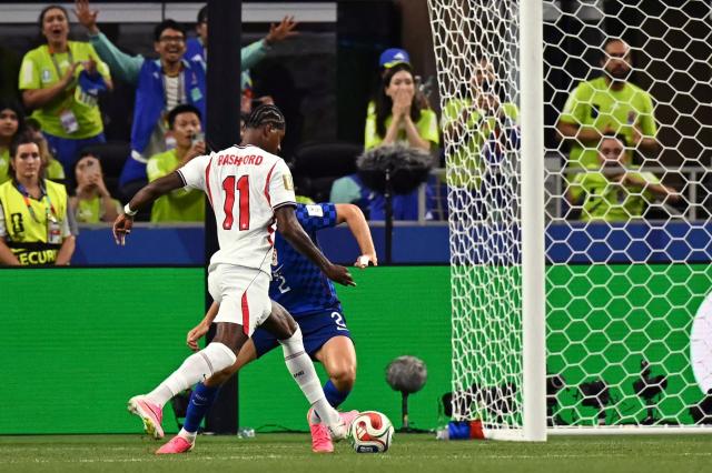 England's forward #11 Marcus Rashford (L) shoots and scores his team's fourth goal during the 2026 World Cup Group L football match between England and Croatia at the Dallas Stadium in Arlington on June 17, 2026.  (Photo by Paul ELLIS / AFP)