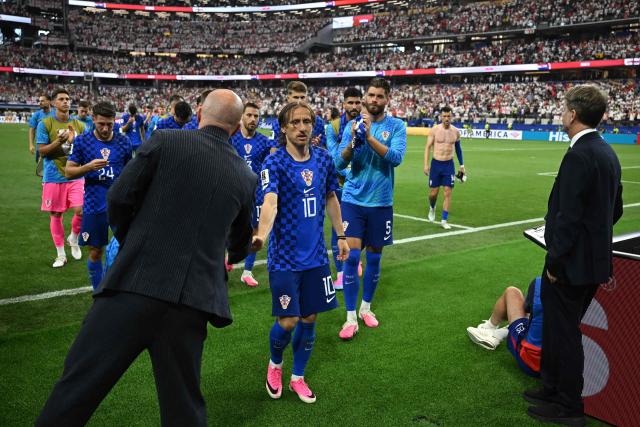 Croatia's midfielder #10 Luka Modric (C) reacts with teammates after winning the  2026 World Cup Group L football match between England and Croatia at the Dallas Stadium in Arlington on June 17, 2026.  (Photo by Paul ELLIS / AFP)