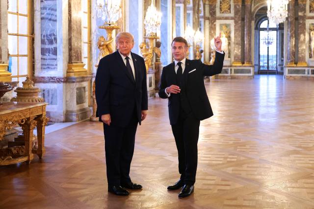 US President Donald Trump (L) receives a tour of the Chateau de Versailles from President of France Emmanuel Macron ahead of a dinner on June 17, 2026 in Versailles, France. The dinner followed the conclusion of this week's Group of 7 (G7) summit in Evian, France. (Photo by Anna Moneymaker / POOL / AFP)