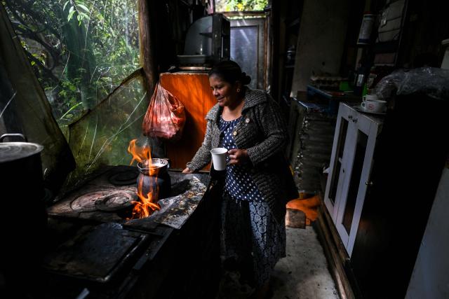 Nury Perez prepares coffee inside her house at the Simon Bolívar neighbourhood, in Bogota, on June 17, 2026. Colombians vote on June 21, 2026 in a presidential runoff pitting a hard-right opera-singer-turned-lawyer against a leftist senator, an election with stark consequences for the country's stumbling peace process with armed groups and strained ties with Washington. (Photo by Juan BARRETO / AFP)