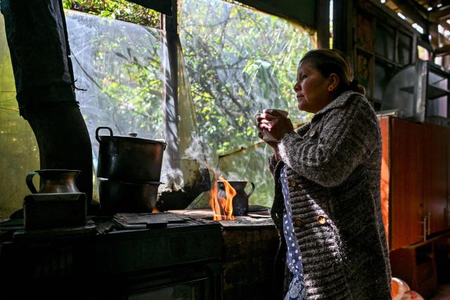 Nury Perez prepares coffee inside her house at the Simon Bolívar neighbourhood, in Bogota, on June 17, 2026. Colombians vote on June 21, 2026 in a presidential runoff pitting a hard-right opera-singer-turned-lawyer against a leftist senator, an election with stark consequences for the country's stumbling peace process with armed groups and strained ties with Washington. (Photo by Juan BARRETO / AFP)