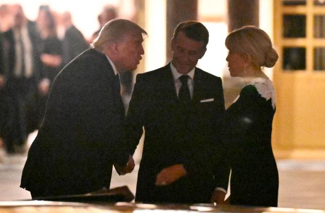 US President Donald Trump takes his leave from France's President Emmanuel Macron and First Lady Brigitte Macron before boarding the presidential limousine following a dinner marking the 250th anniversary of US independence at the Château de Versailles in Versailles, southwest of Paris, on June 17, 2026. (Photo by Mandel NGAN / AFP)