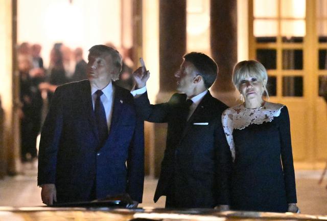 US President Donald Trump takes his leave from France's President Emmanuel Macron and First Lady Brigitte Macron before boarding the presidential limousine following a dinner marking the 250th anniversary of US independence at the Château de Versailles in Versailles, southwest of Paris, on June 17, 2026. (Photo by Mandel NGAN / AFP)