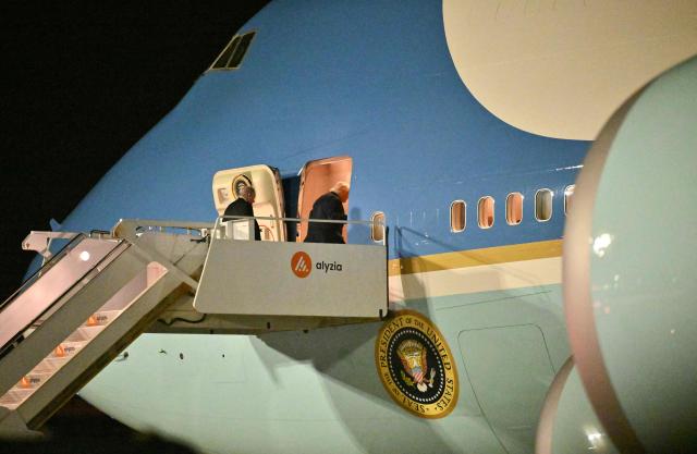 US President Donald Trump (front), who attended the G7 summit in France, boards Air Force One at Paris Orly Airport, 13 kilometres (8 miles) south of Paris, in the early hours of June 18, 2026, after attending a dinner at the Château de Versailles marking the 250th anniversary of US independence. (Photo by Mandel NGAN / AFP)