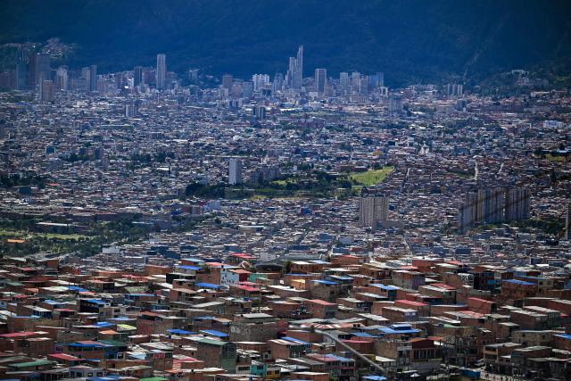 This image shows low-income housing (foreground) at Ciudad Bolivar neighbourhood, in southern Bogota, on June 17, 2026. Colombians vote on June 21, 2026 in a presidential runoff pitting a hard-right opera-singer-turned-lawyer against a leftist senator, an election with stark consequences for the country's stumbling peace process with armed groups and strained ties with Washington. (Photo by Juan BARRETO / AFP)