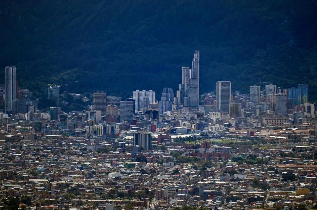 This image shows office buildings and the city center in Bogota, on June 17, 2026. Colombians vote on June 21, 2026 in a presidential runoff pitting a hard-right opera-singer-turned-lawyer against a leftist senator, an election with stark consequences for the country's stumbling peace process with armed groups and strained ties with Washington. (Photo by Juan BARRETO / AFP)