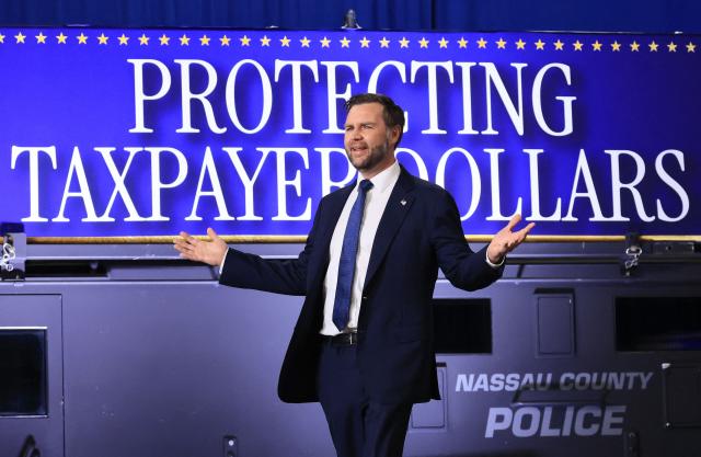 US Vice President JD Vance gestures as he arrives to deliver remarks on the administration's "crackdown on crime and fraud" during an event at Gold Coast Studios in Bethpage, New York, on June 17, 2026. Vance’s visit comes after the Justice Department filed a lawsuit this week against New York state officials over alleged Medicaid fraud related to the state’s $10 billion home-care program. (Photo by Spencer Platt / POOL / AFP)