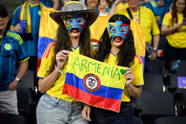 Colombian fans pose for a photo cheering for their team ahead of the 2026 World Cup Group K football match between Uzbekistan and Colombia at the Mexico City Stadium in Mexico City on June 17, 2026.  (Photo by Alfredo ESTRELLA / AFP)