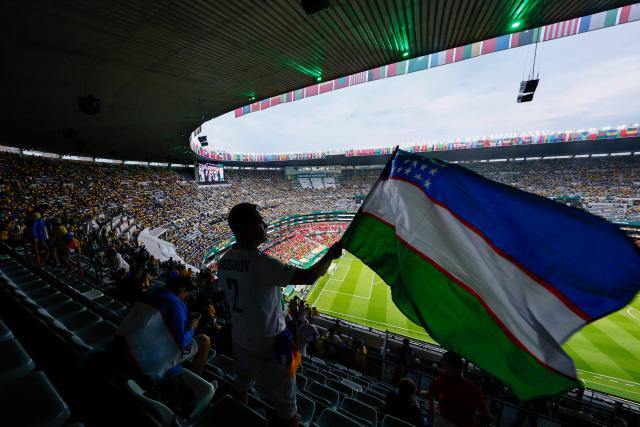 An Uzbek fan waves a national flag ahead of the 2026 World Cup Group K football match between Uzbekistan and Colombia at the Mexico City Stadium in Mexico City on June 17, 2026.  (Photo by Rodrigo Oropeza / AFP)