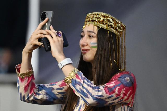 A Uzbek fan takes a photo ahead of the 2026 World Cup Group K football match between Uzbekistan and Colombia at the Mexico City Stadium in Mexico City on June 17, 2026.  (Photo by CARL DE SOUZA / AFP)