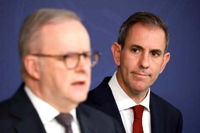 Australian Treasurer Jim Chalmers (R) listens to Australia’s Prime Minister Anthony Albanese speak during a press conference regarding budget changes in Sydney on June 18, 2026. (Photo by DAVID GRAY / AFP)