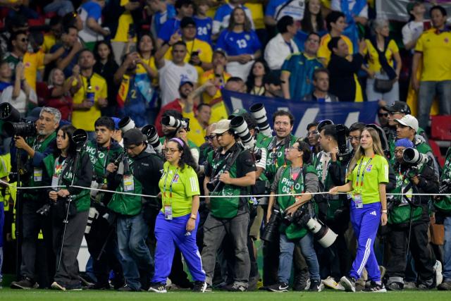 Photographers stand on the touchline ahead of the 2026 World Cup Group K football match between Uzbekistan and Colombia at the Mexico City Stadium in Mexico City on June 17, 2026.  (Photo by Alfredo ESTRELLA / AFP)