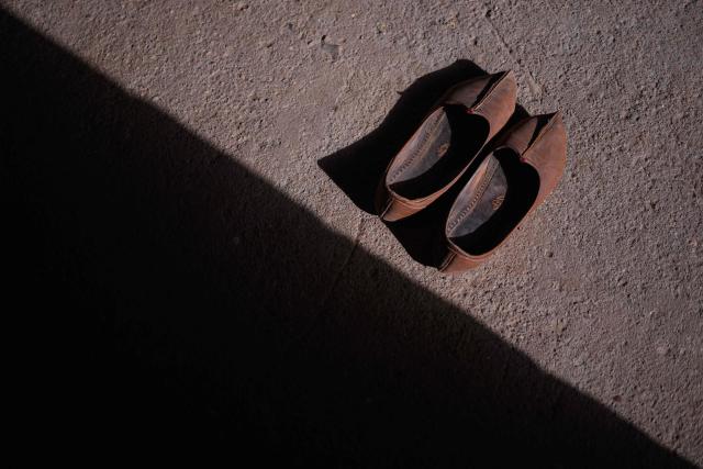 This photograph taken on May 29, 2026 shows a tradititonal leather footwear called juti at herdsman Sawai Singh Bhati's house in Sanwata village on the outskirts of Rajasthan's Jaisalmer city. In India's hot plains, scorching summers have become increasingly harder to endure, requiring adaptations and forcing life into the hours of dark before the sun turns punishing. Temperatures in Singh's Sanwata village hit 45C in early June, as is often during the summer with the highest temperature recorded in the area as 49C. (Photo by Manan VATSYAYANA / AFP)