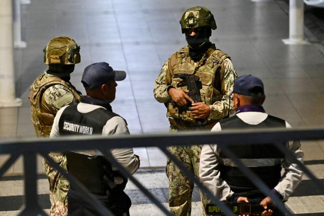 Members of the army and airport security guard the exterior of the international arrivals area after a criminal gang leader was shot dead at Jose Joaquin de Olmedo International Airport in Guayaquil, Ecuador, on June 17, 2026. Ecuador's Interior Minister John Reimberg identified the deceased as Carlos Suastegui, leader of the Las Aguilas gang, an armed wing of the feared criminal group Los Choneros. (Photo by MARCOS PIN / AFP)