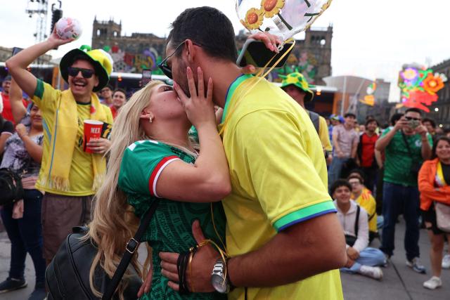 A couple kiss at the FIFA Fan Festival in Mexico City's Zocalo during the 2026 World Cup Group K football match between Uzbekistan and Colombia on June 17, 2026. (Photo by LUIS CORTES / AFP)