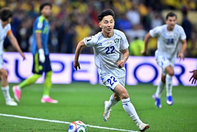 Uzbekistan's midfielder #22 Abbosbek Fayzullaev celebrates scoring his team's first goal during the 2026 World Cup Group K football match between Uzbekistan and Colombia at the Mexico City Stadium in Mexico City on June 17, 2026.  (Photo by CARL DE SOUZA / AFP)