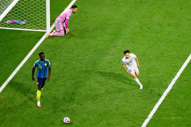 Uzbekistan's midfielder #22 Abbosbek Fayzullaev celebrates scoring his team's first goal past Colombia's goalkeeper #12 Camilo Vargas and defender #23 Davinson Sanchez during the 2026 World Cup Group K football match between Uzbekistan and Colombia at the Mexico City Stadium in Mexico City on June 17, 2026.  (Photo by Rodrigo Oropeza / AFP)