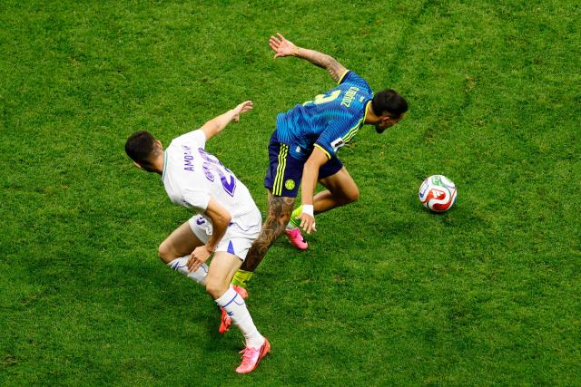 Uzbekistan's forward #20 Azizbek Amonov and Colombia's defender #02 Daniel Munoz fight for the ball during the 2026 World Cup Group K football match between Uzbekistan and Colombia at the Mexico City Stadium in Mexico City on June 17, 2026.  (Photo by Rodrigo Oropeza / AFP)