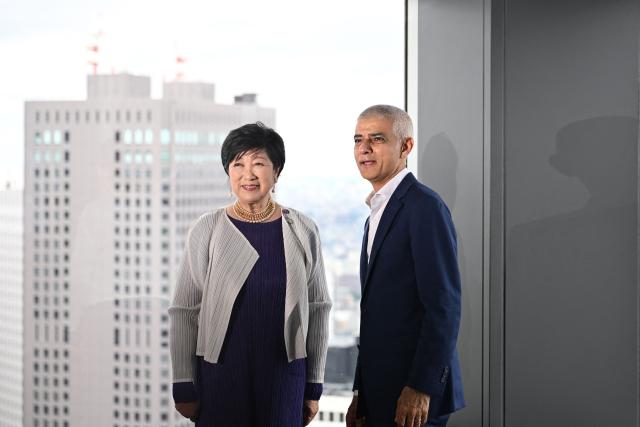 London's Mayor Sadiq Khan (R) and Tokyo Governor Yuriko Koike visit the observation deck on the 45th floor of the Tokyo Metropolitan Government building in Tokyo on June 18, 2026. (Photo by Philip FONG / AFP)