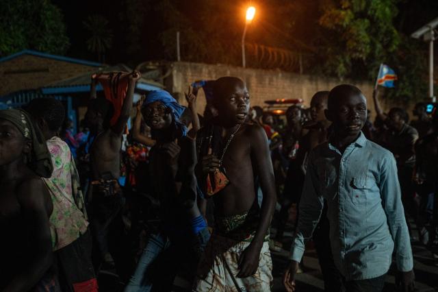 Congolese supporters dressed in the colors of the Democratic Republic of Congo's national flag celebrate the Leopards' equalizing goal in a street in Bunia at night during a FIFA World Cup match between DR Congo and Portugal in Bunia, Ituri Province, Democratic Republic of Congo, on June 17, 2026. Ituri, a remote province in northeastern Congo, is at the epicenter of the 17th Ebola outbreak, declared on May 15 in the DRC. The virus has infected 837 people and caused 196 deaths so far, according to the latest official figures.
In the city of Bunia alone, 215 cases of infection have been confirmed, while the DRCs testing capacity is limited. The scale of the health crisis is still unknown, scientists, aid workers, and international health authorities acknowledge.
But for 90 minutes of the match, some of the roughly 100 million inhabitants say they were able to escape the worries linked to the epidemic, the conflict in the east of the country, and the violence of armed groups. (Photo by Jospin Mwisha / AFP)