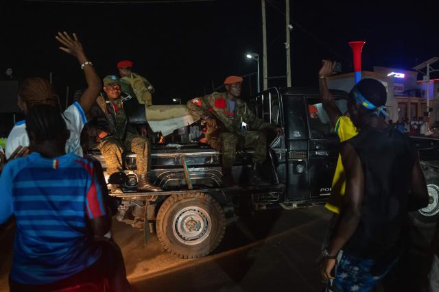 Military Police officers patrol in a pickup truck through the streets of Bunia as Congolese supporters celebrate the Leopards' equalizing goal in a street in Bunia at night during a FIFA World Cup match between DR Congo and Portugal in Bunia, Ituri Province, Democratic Republic of Congo, on June 17, 2026. Ituri, a remote province in northeastern Congo, is at the epicenter of the 17th Ebola outbreak, declared on May 15 in the DRC. The virus has infected 837 people and caused 196 deaths so far, according to the latest official figures.
In the city of Bunia alone, 215 cases of infection have been confirmed, while the DRCs testing capacity is limited. The scale of the health crisis is still unknown, scientists, aid workers, and international health authorities acknowledge.
But for 90 minutes of the match, some of the roughly 100 million inhabitants say they were able to escape the worries linked to the epidemic, the conflict in the east of the country, and the violence of armed groups. (Photo by Jospin Mwisha / AFP)