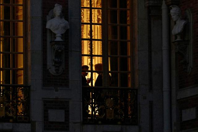TOPSHOT - France's President Emmanuel Macron (L) and US President Donald Trump (R) talk inside Chateau de Versailles ahead of a dinner to celebrate the 250th anniversary of the independence of the United States, in Versailles southwest of Paris on June 17, 2026. (Photo by Mandel NGAN / AFP)