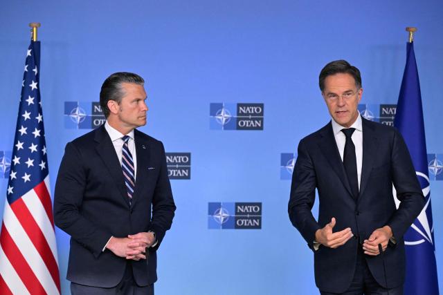 NATO Secretary General Mark Rutte (R) and US Secretary of Defence Pete Hegseth deliver remarks before a NATO Defence Ministers meeting at the NATO headquarters, in Brussels, on June 18, 2026. (Photo by JOHN THYS / AFP)
