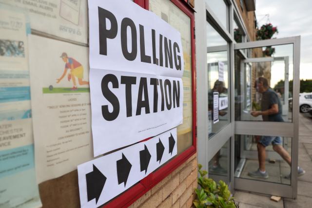 A man walks into a makeshift polling station at a parish centre in Winstanley, Wigan, part of the parliamentary constituency for the Makerfield by-election, after polls opened at 7am on June 18, 2026. Britain holds a unique vote on June 18 that could trigger the endgame for Labour leader Keir Starmer's beleaguered premiership, or win him a reprieve. (Photo by Darren Staples / AFP)