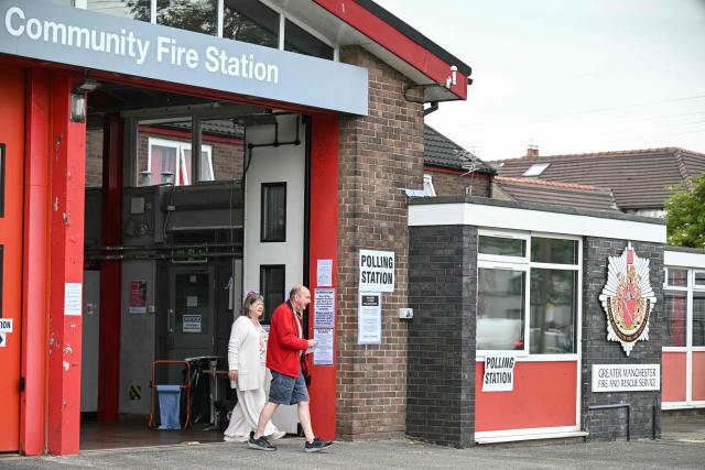 People exit a makeshift polling station set up at a fire station in Hindley, part of the parliamentary constituency for the Makerfield by-election, after the polls opened at 7am on June 18, 2026. Britain holds a unique vote on June 18 that could trigger the endgame for Labour leader Keir Starmer's beleaguered premiership, or win him a reprieve. (Photo by Oli SCARFF / AFP)