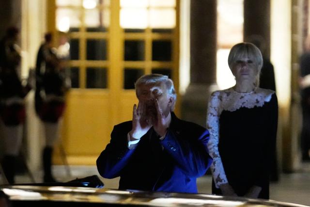 US President Donald Trump (c) walks to the presidential limousine alongside France's First Lady Brigitte Macron following a dinner marking the 250th anniversary of US independence at the Château de Versailles in Versailles, southwest of Paris, on June 17, 2026. (Photo by Michel Euler / POOL / AFP)