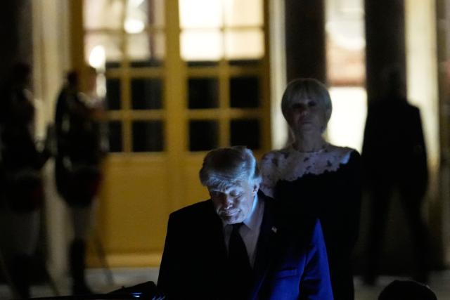 US President Donald Trump (c) walks to the presidential limousine alongside France's First Lady Brigitte Macron following a dinner marking the 250th anniversary of US independence at the Château de Versailles in Versailles, southwest of Paris, on June 17, 2026. (Photo by Michel Euler / POOL / AFP)