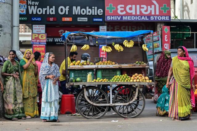 Daily wage workers wait to be hired for work in Ahmedabad on June 18, 2026. (Photo by Shammi MEHRA / AFP)