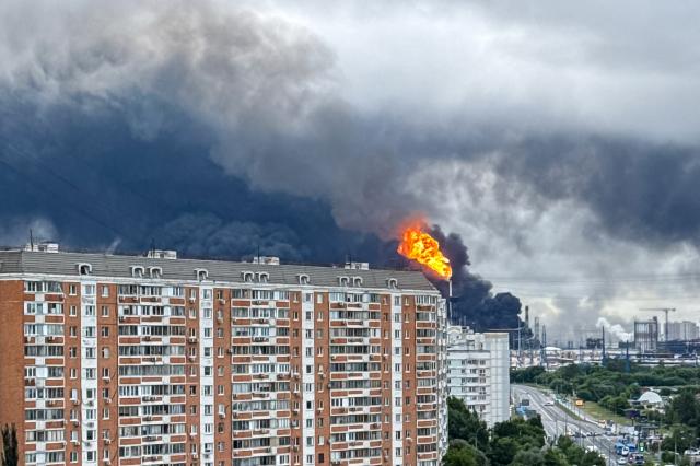 Black smoke rises from the area of the Russian oil producer Gazprom Neft's Moscow oil refinery on the south-eastern outskirts of Moscow on June 18, 2026. Moscow was fending off a "large-scale" drone attack from Ukraine, with several drones reaching an oil refinery, the city's mayor Sergey Sobyanin said early on June 18, 2026. (Photo by AFP)