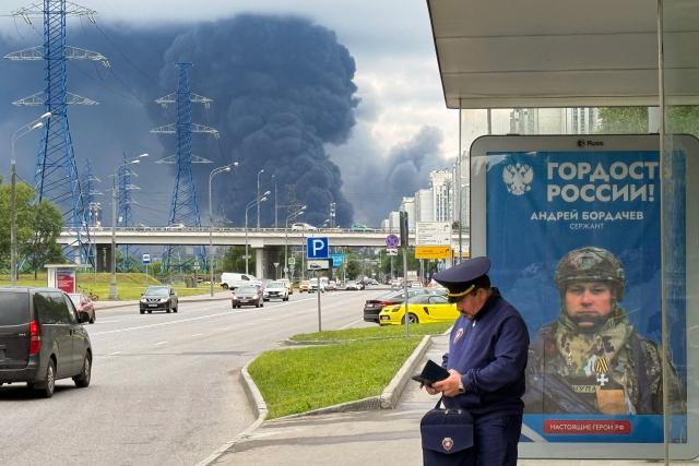 Black smoke rises from the area of the Russian oil producer Gazprom Neft's Moscow oil refinery on the south-eastern outskirts of Moscow on June 18, 2026. Moscow was fending off a "large-scale" drone attack from Ukraine, with several drones reaching an oil refinery, the city's mayor Sergey Sobyanin said early on June 18, 2026. (Photo by AFP)