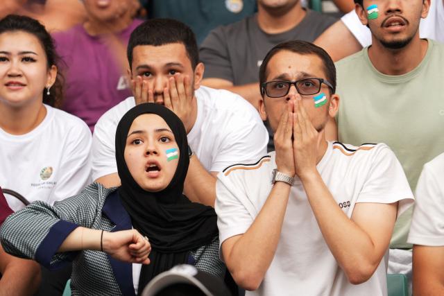 Uzbek fans react as they watch a live broadcast of the 2026 World Cup Group K football match between Uzbekistan and Colombia at the Milliy Stadium in Tashkent on June 18, 2026. (Photo by Timur ISMOILOV / AFP)
