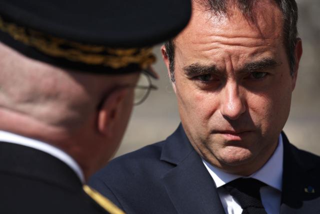 France's Prime Minister Sebastien Lecornu (R) speaks with Paris Police Prefect Patrice Faure as he arrives for the commemorative ceremony for the 86th anniversary of the Appeal of 18 June, in Mont Valerien, near Paris, on June 18, 2026. (Photo by SIMON WOHLFAHRT / POOL / AFP)